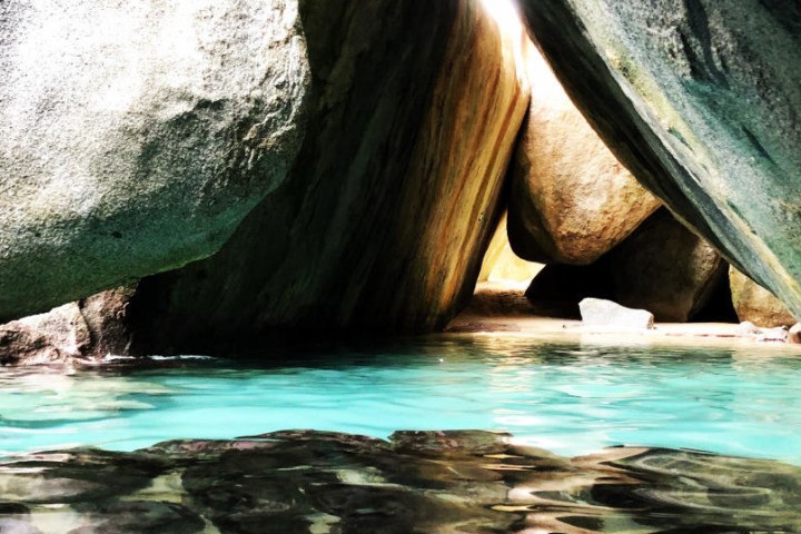 a close up of a rock next to a body of water