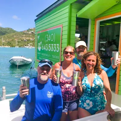 a group of people standing in front of a boat