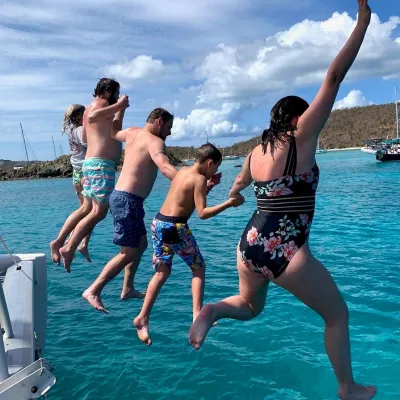 a woman standing next to a body of water