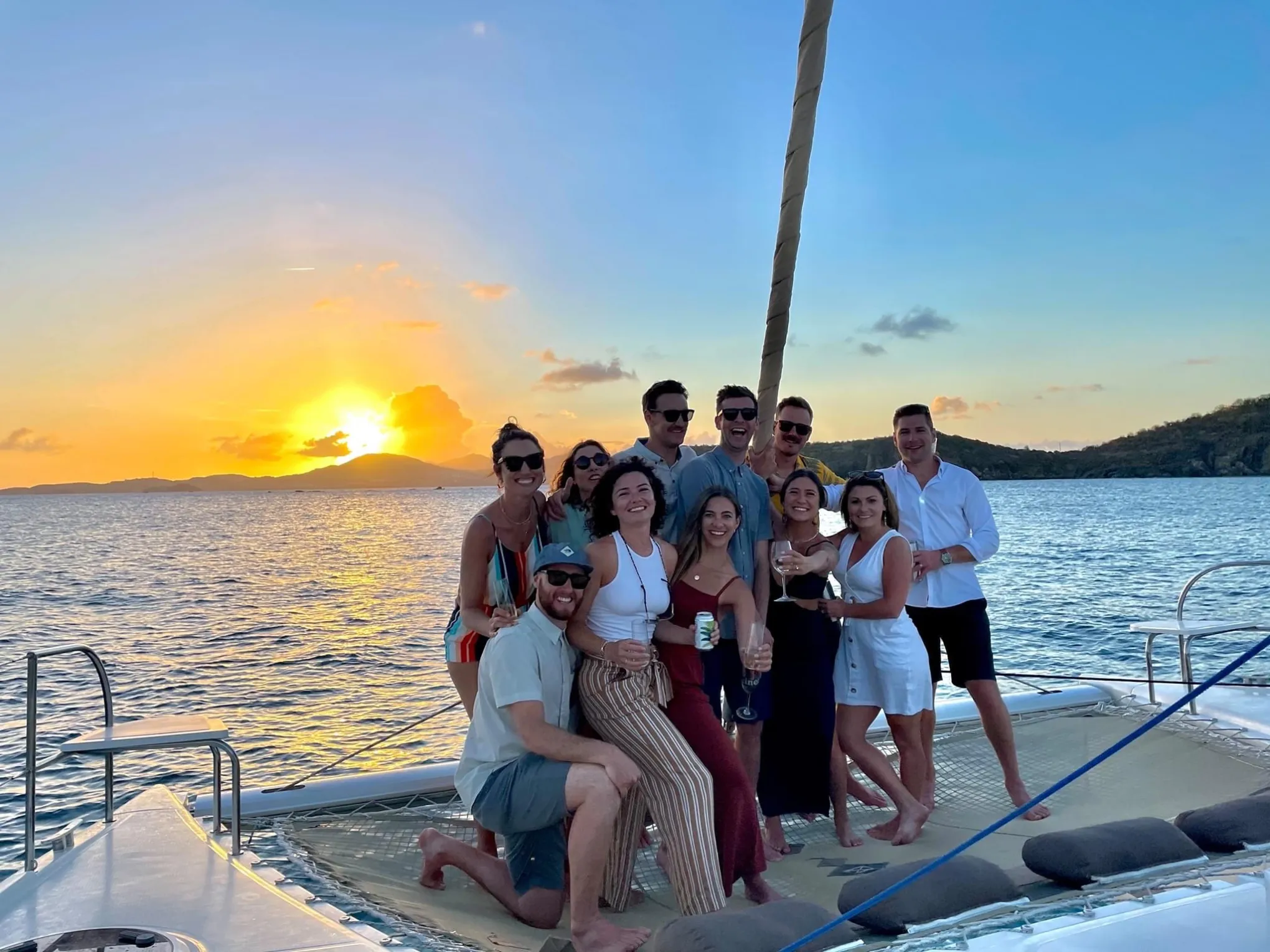 a group of people standing next to a body of water