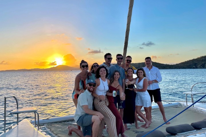a group of people standing next to a body of water