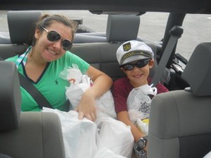 a couple of people sitting around a car