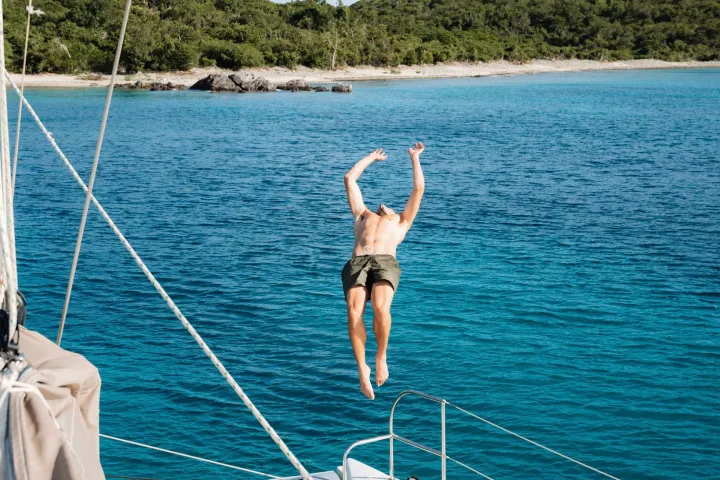a man standing next to a body of water