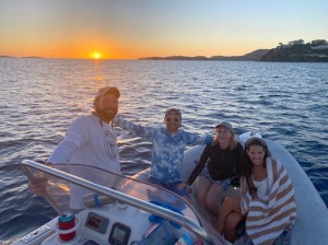 a group of people in a boat on a body of water
