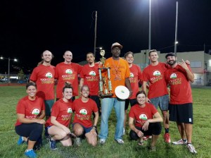 a group of people posing for a picture with a frisbee