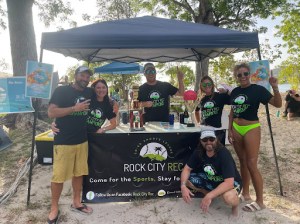 a group of people that are standing in the sand
