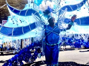 a group of people standing in front of a blue wall