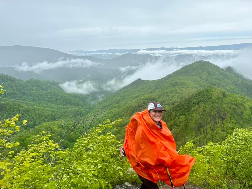 a man sitting on top of a mountain