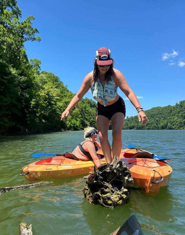 a person riding on the back of a boat in the water