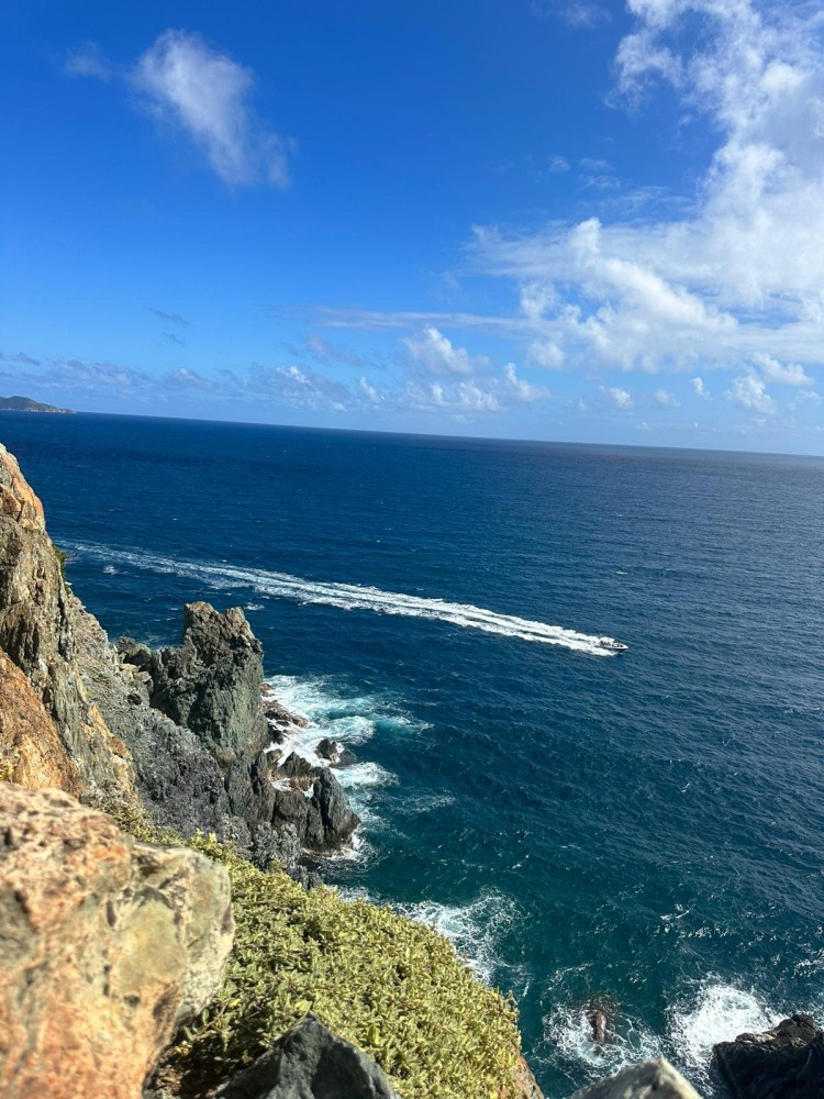 a large body of water with a mountain in the ocean