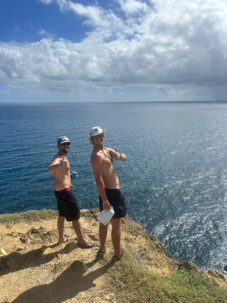 a man standing next to a body of water