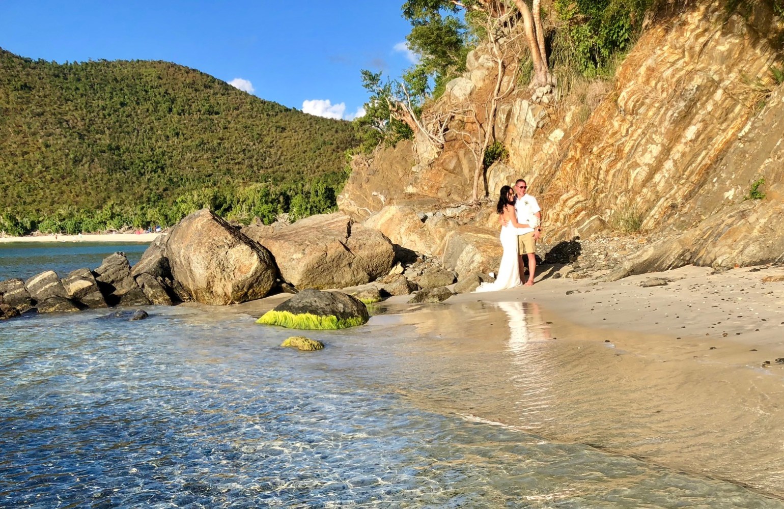 a man standing on a rock in the water