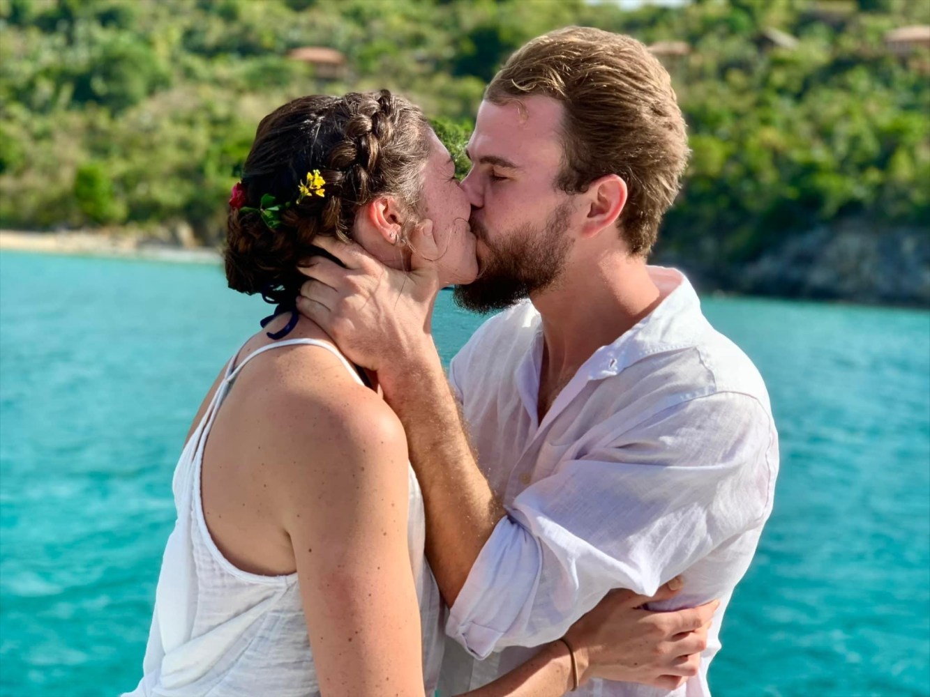 a man and a woman looking at the water