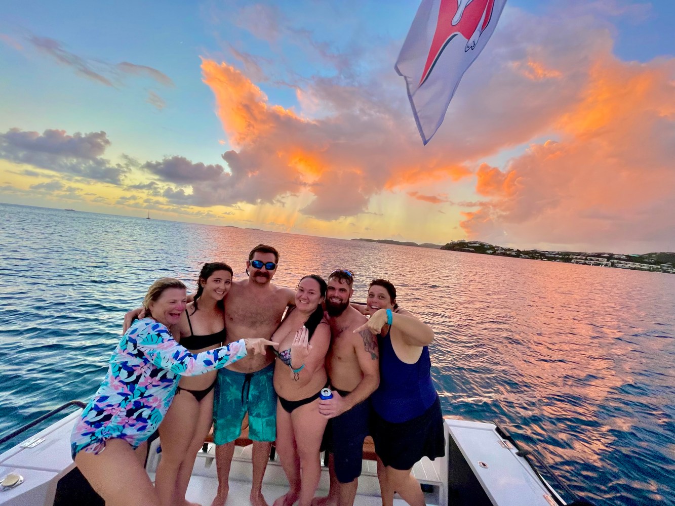 a group of people standing next to a body of water