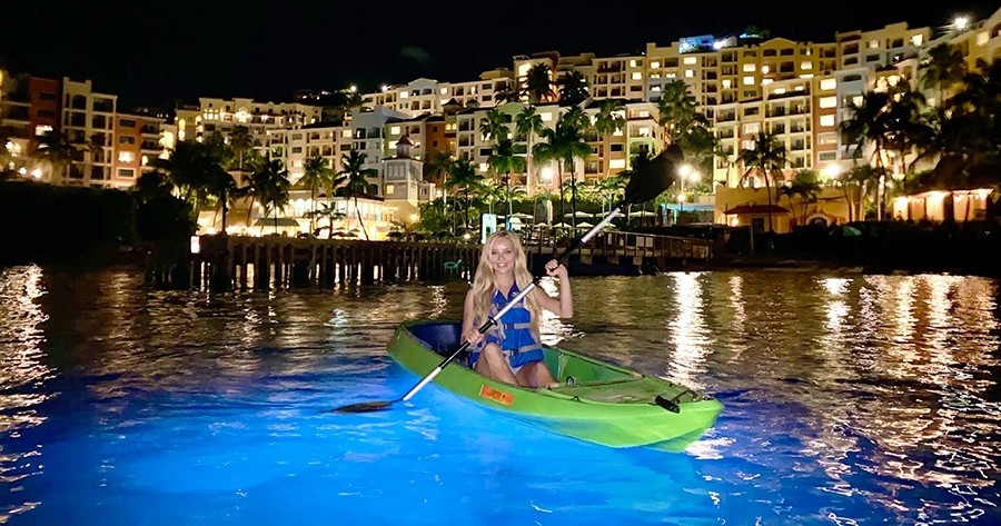 a person riding on the back of a boat in the water