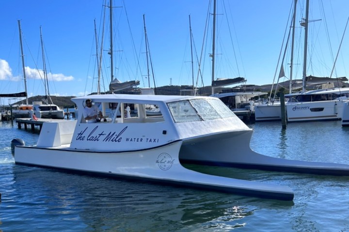 a boat is docked next to a body of water