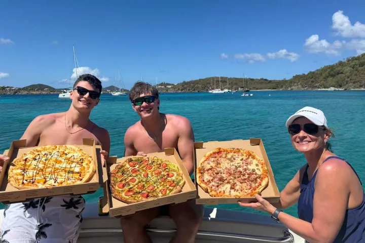 a woman sitting at a table with food and water